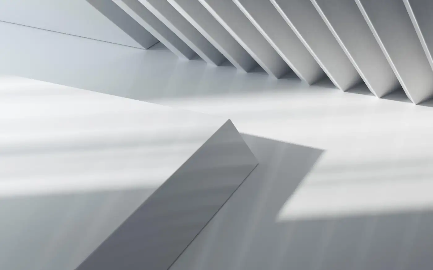 Angular white forms under raking light, one dark wedge cutting across the composition