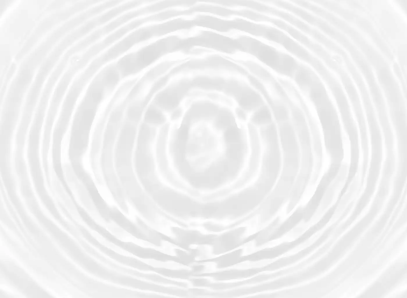 Faint ripples spreading across a still, pale surface