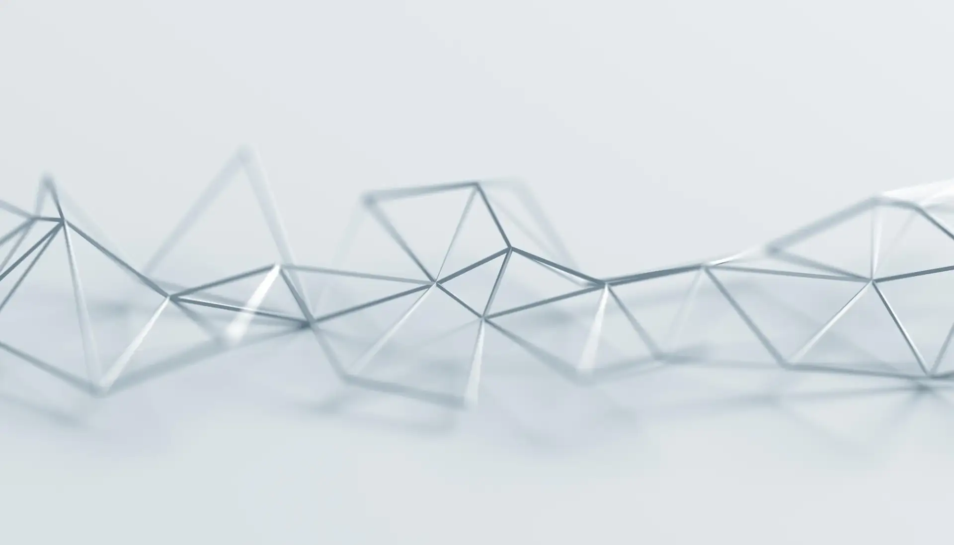 A faceted lattice of thin struts stretching across a pale field