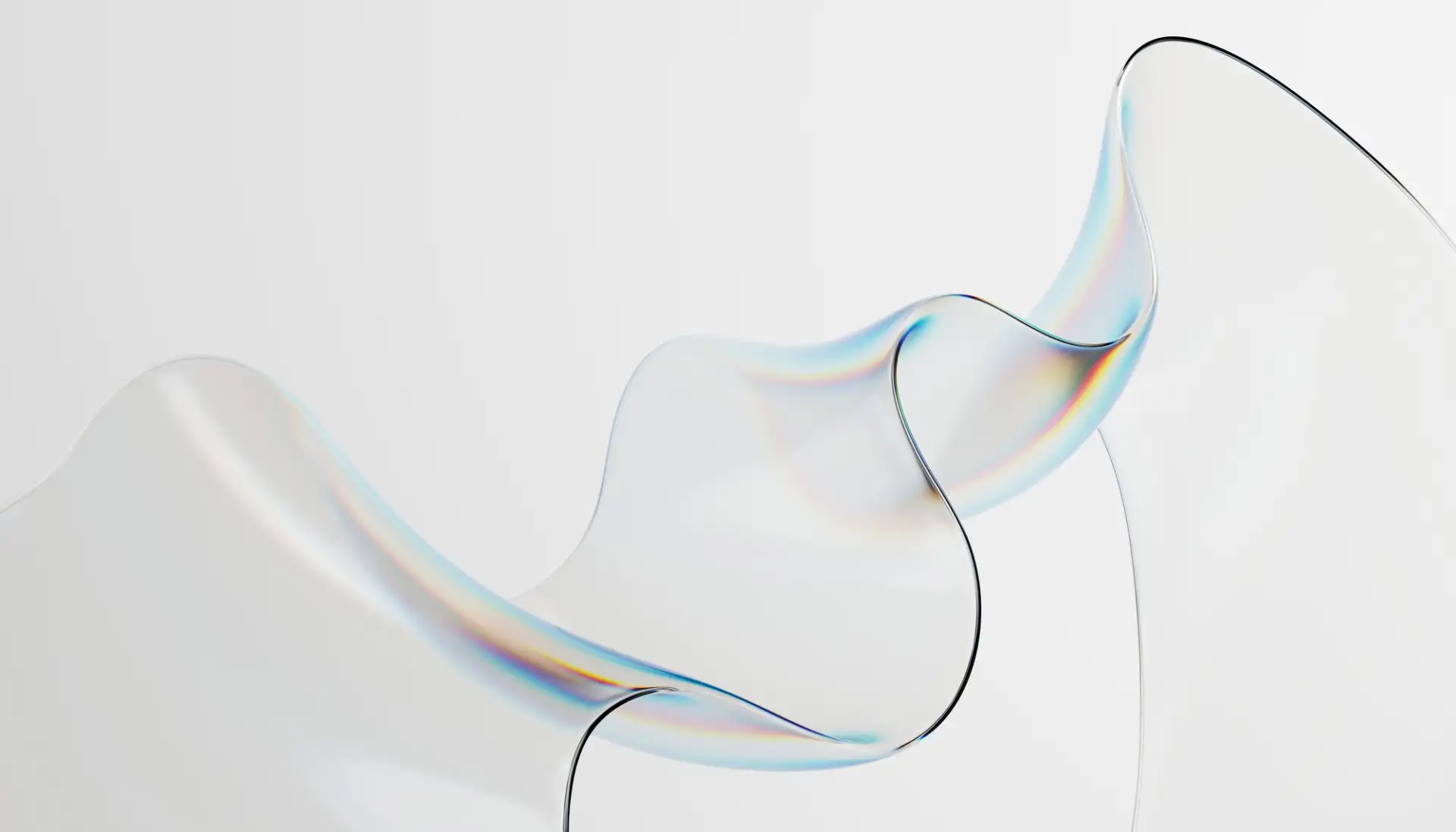 A twist of clear glass on white, its edge catching a faint band of color