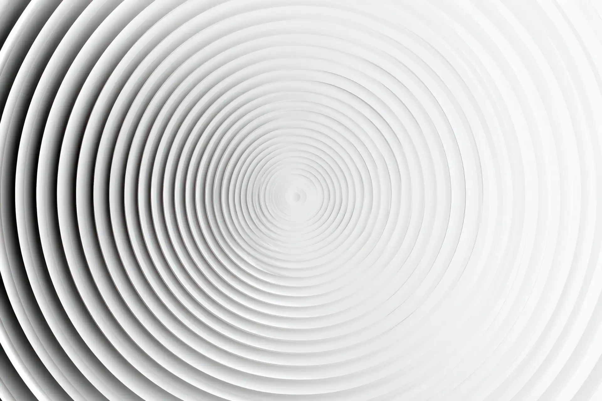Tight concentric rings spiraling inward on a white surface